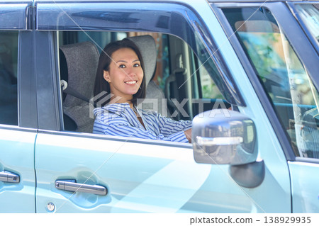 Japanese woman in the driver's seat of a car 138929935