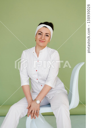 Female Physician Posing on White Designer Chair Female Physician Posing on White Designer Chair 138930026
