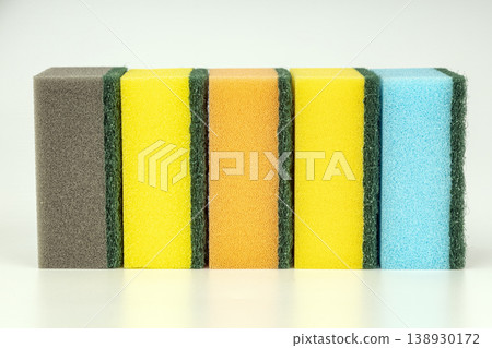 Set of Six Colorful Kitchen Sponges with Green Scrubbing Pads Arranged in Row Isolated on White Background 138930172