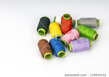 Assorted Colorful Thread Spools with Bright Green Cardboard Tubes for Sewing, Embroidery, and Craft Projects 138930182