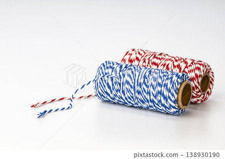 Colorful Red White and Blue Striped Baker's Twine Spools on Cardboard Rolls for Wrapping and Decoration Colorful Red White and Blue Striped Baker's Twine Spools on Cardboard Rolls for Wrapping and Decoration 138930190