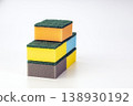 Three Stacked Kitchen Cleaning Sponges with Abrasive Green Scrubbing Pads on White Background 138930192