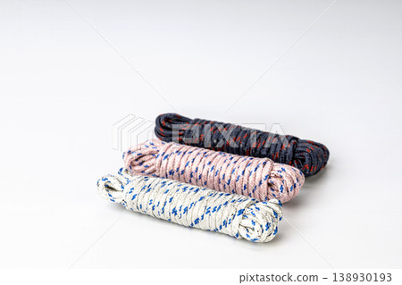 Set of Three Coiled Utility Ropes with Colored Tracer Strands Isolated on White Set of Three Coiled Utility Ropes with Colored Tracer Strands Isolated on White 138930193