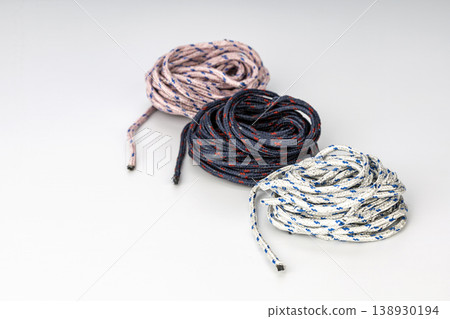 Set of Three Coiled Braided Ropes in White with Blue Stripes, Navy with Red Accents, and Light Pink with Blue Speckles Set of Three Coiled Braided Ropes in White with Blue Stripes, Navy with Red Accents, and Light Pink with Blue Speckles 138930194