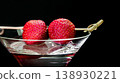 Strawberries garnishing martini cocktail drink on black background 138930221