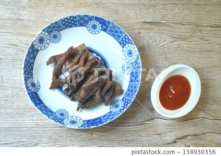 fried crispy salty fermenting beef fat meat with pepper on plate dipping spicy chili sauce fried crispy salty fermenting beef fat meat with pepper on plate dipping spicy chili sauce 138930356