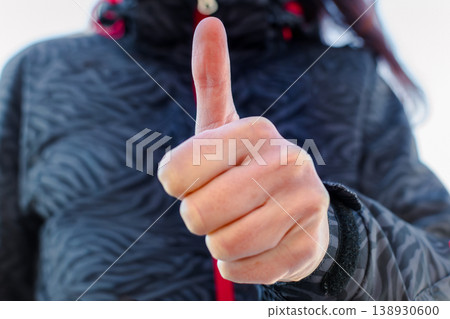 Woman making gesture with her hand outdoors Woman making gesture with her hand outdoors 138930600
