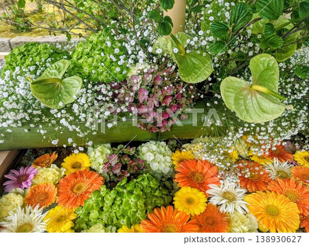 Colorful flower arrangements in a water basin and bamboo containers, a Japanese-style floral arrangement to celebrate early summer. Colorful flower arrangements in a water basin and bamboo containers, a Japanese-style floral arrangement to celebrate early summer. 138930627