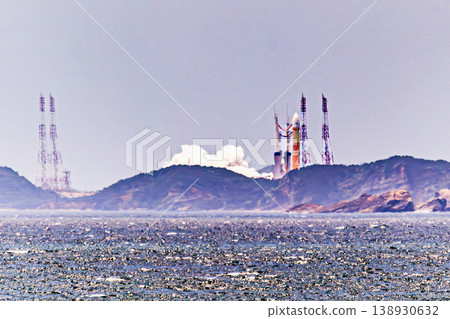 An H-III rocket launching from Tanegashima Space Center and the spreading plume of smoke. 138930632
