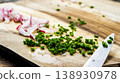Fresh chopped radishes and chives on cutting board 138930978