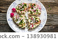 Open-faced egg salad sandwiches with radishes and chives 138930981