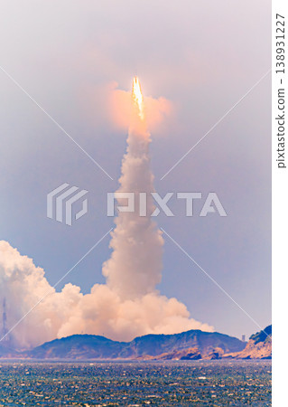 The H-III rocket ascends, engulfed in flames, and a column of smoke. The H-III rocket ascends, engulfed in flames, and a column of smoke. 138931227