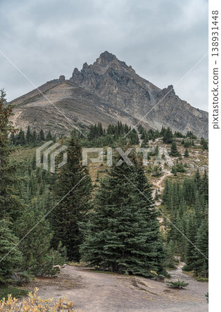 The towering peaks where the soul of the earth resides: Jimmy Simpson Mountain and the autumn forest enveloped in silence under a cloudy sky. 138931448