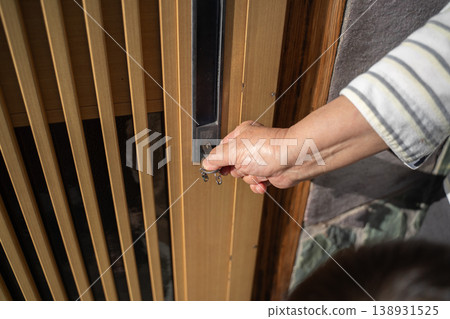 An elderly person opening the front door An elderly person opening the front door 138931525