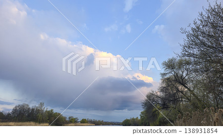Spring river landscape with green trees, reflections, and pink clouds in the sky. Tourism. Spring river landscape with green trees, reflections, and pink clouds in the sky. Tourism. 138931854