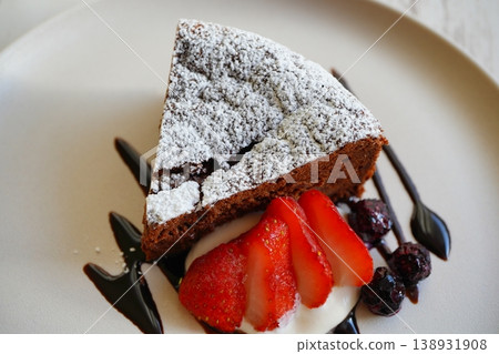 A top-down photo of a chocolate cake and strawberry dessert. A top-down photo of a chocolate cake and strawberry dessert. 138931908