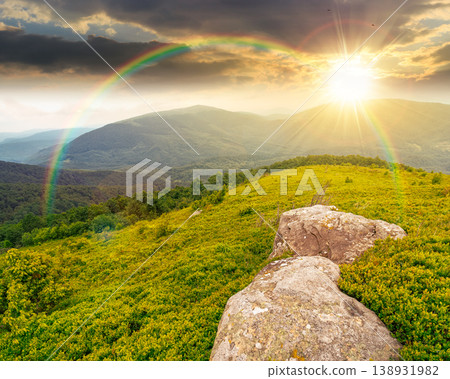 sunset over summer landscape of alps. hillside meadows in mountain scenery. countryside highland view from the top of a hill. nature background with green slope. weather with rainbow 138931982