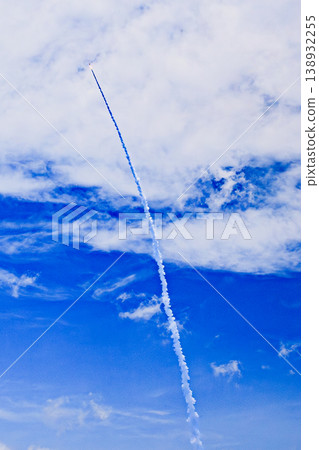The launch trajectory of the H3 rocket stretches through the clouds. 138932255