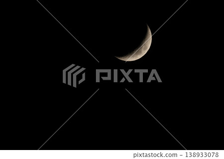 Crescent moon floating in the night sky 138933078