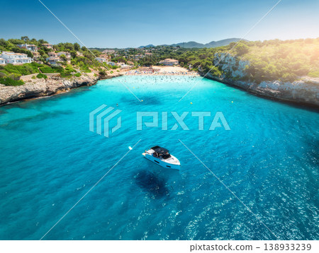 Aerial view of boat and serene sandy beach cove 138933239