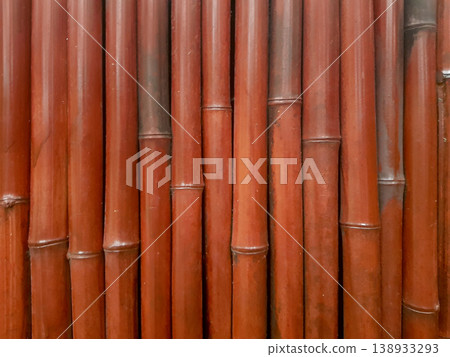 Bamboo wall structure with brown hues in a natural outdoor setting during daytime 138933293