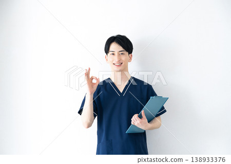 Young man wearing scrubs Young man wearing scrubs 138933376