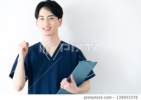 Young man wearing scrubs Young man wearing scrubs 138933378