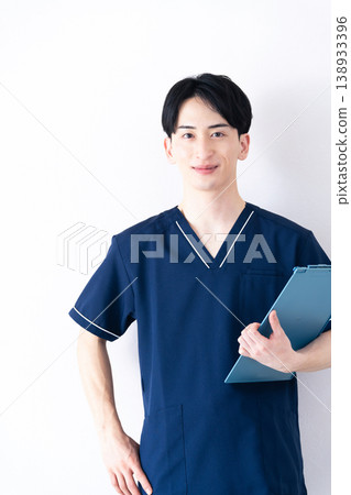 Young man wearing scrubs Young man wearing scrubs 138933396