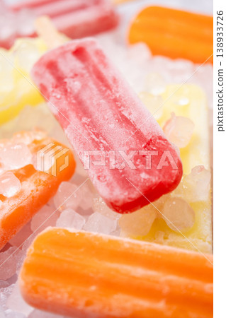Colorful fruit popsicles on crushed ice Colorful fruit popsicles on crushed ice 138933726