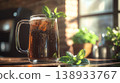 Refreshing Iced Root Beer or Cola in a Glass Mug with Fresh Mint Leaves on a Wooden Table 138933767