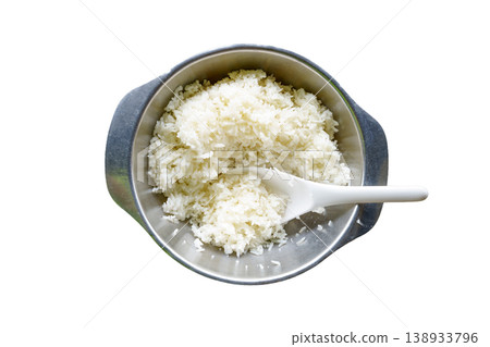 Top view of cooked jasmine white rice in a stainless steel bowl with a white plastic paddle. Isolated on white background. Clean food concept for culinary and healthy eating designs. Top view of cooked jasmine white rice in a stainless steel bowl with a white plastic paddle. Isolated on white background. Clean food concept for culinary and healthy eating designs. 138933796