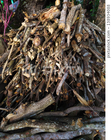 Large pile of chopped tree branches and broken logs with rough bark and splintered textures stacked outdoors for firewood and forestry cleanup themes Large pile of chopped tree branches and broken logs with rough bark and splintered textures stacked outdoors for firewood and forestry cleanup themes 138934088