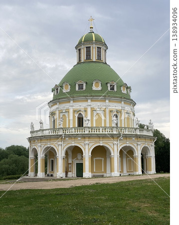 Russian orthodox church with green dome, ornate facade and lawn, perfect for a historical background 138934096
