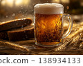 Traditional Cold Kvass in a Glass Mug with Rye Bread and Barley Ears on a Wooden Background 138934133