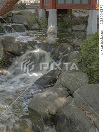 A refreshing stream that cleanses the soul. A cool babbling brook flows through the rocks of the garden. 138934373