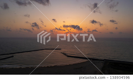 [Kanazawa City, Ishikawa Prefecture] Sunset at Kanaiwa Coast - Sunset over the Sea of Japan / Coast illuminated by the setting sun / Drone footage 138934596