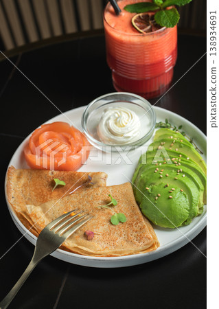 Roasted thin pancakes with smoked salmon and sauce Roasted thin pancakes with smoked salmon and sauce 138934691