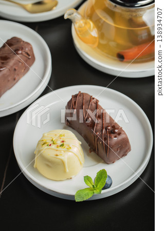 Delicious glazed curd snacks with fresh blueberries and mint on light grey table, closeup Delicious glazed curd snacks with fresh blueberries and mint on light grey table, closeup 138934707