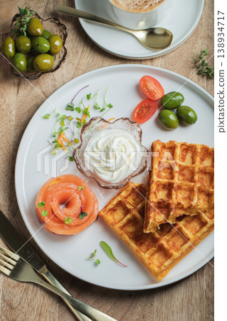 Crunchy waffle fries with sour cream dip served in a basket 138934717