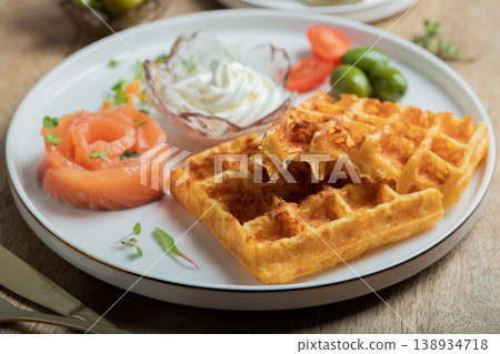 Crunchy waffle fries with sour cream dip served in a basket 138934718