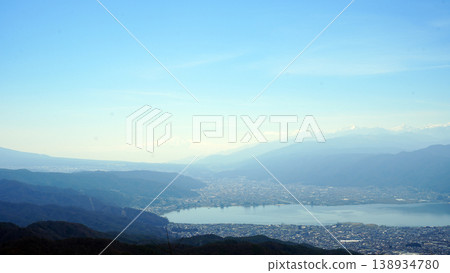 Lake Suwa and Mount Fuji shrouded in mist, as seen from Takabocchi. 138934780