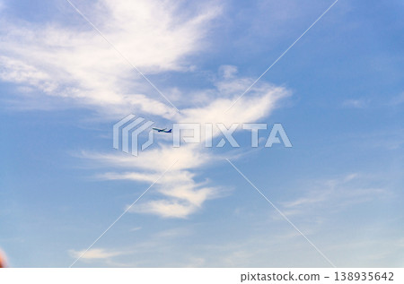 Airplane takes off into a blue sky Airplane takes off into a blue sky 138935642