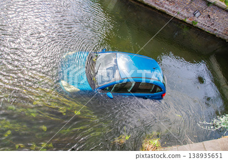 Blue vehicle drown in water canal Blue vehicle drown in water canal 138935651