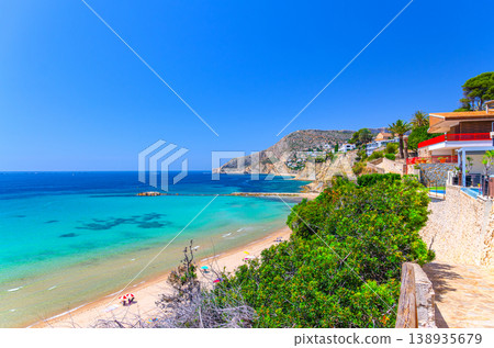 Aerial panoramic view coastline Costa Blanca coast with sandy beach, touristic path, residential houses in Calpe town Aerial panoramic view coastline Costa Blanca coast with sandy beach, touristic path, residential houses in Calpe town 138935679