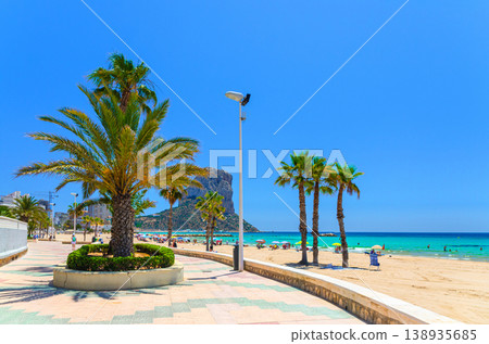 Aerial panoramic view coastline Costa Blanca coast with sandy beach, touristic path, residential houses in Calpe town Aerial panoramic view coastline Costa Blanca coast with sandy beach, touristic path, residential houses in Calpe town 138935685