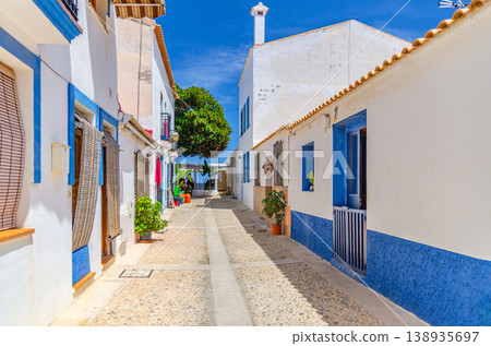 Typical old buildings traditional white-blue houses on pedestrian empty street Tabarca Island Typical old buildings traditional white-blue houses on pedestrian empty street Tabarca Island 138935697