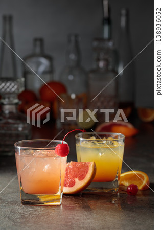 Cocktails with ice, grapefruit juice, and orange juice garnished with maraschino cherry. 138936052
