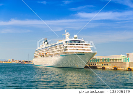 Grand cruise ship moored near pier in harbor Port of Alicante seaport Grand cruise ship moored near pier in harbor Port of Alicante seaport 138936179