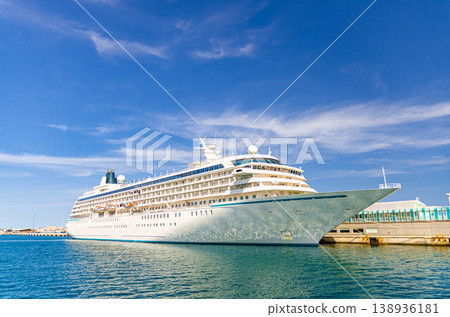 Grand cruise ship moored near pier in harbor Port of Alicante seaport Grand cruise ship moored near pier in harbor Port of Alicante seaport 138936181