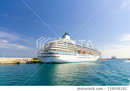 Grand cruise ship moored near pier in harbor Port of Alicante seaport Grand cruise ship moored near pier in harbor Port of Alicante seaport 138936182